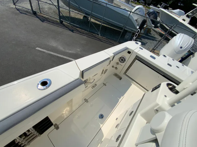 Slide: The Image of 2025 Cobia 265 CC boat interior, featuring spacious deck and modern amenities. - 49