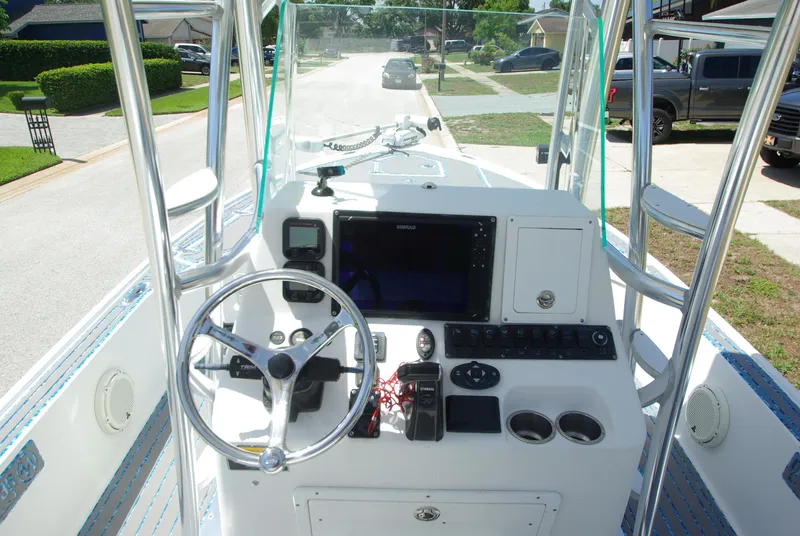 Slide: The Image of 2010 Cape Horn Center Console boat dashboard with steering wheel and navigation equipment. - 13