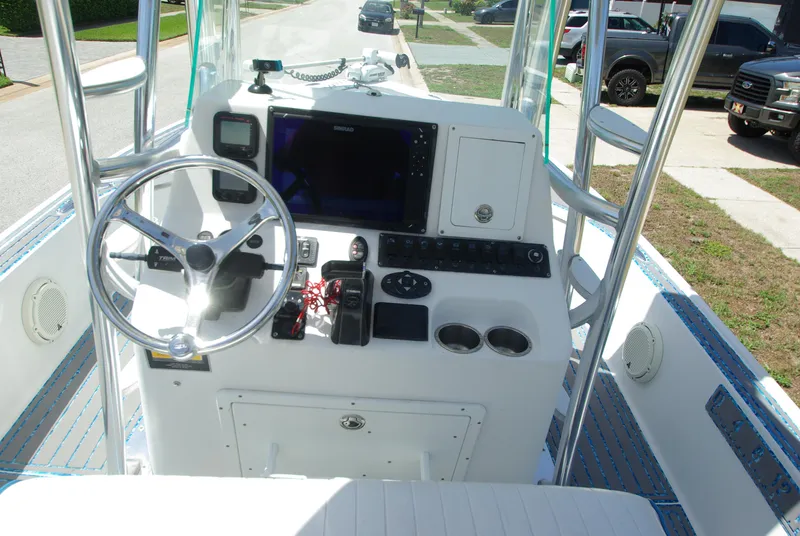 Slide: The Image of 2010 Cape Horn Center Console boat dashboard with steering wheel and navigation equipment. - 16