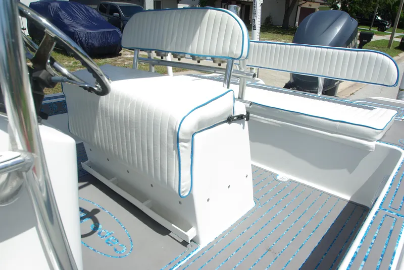 Slide: The Image of 2010 Cape Horn Center Console boat interior with white cushioned seating and steering wheel. - 21