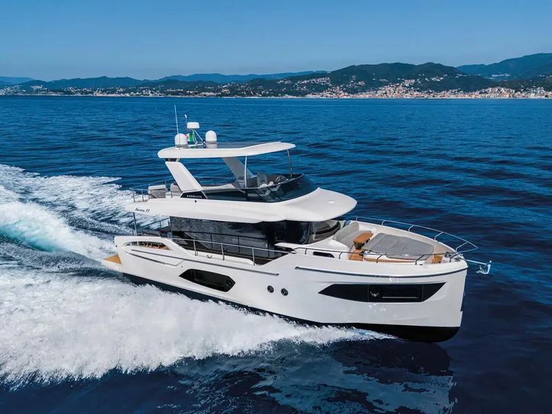 The Image of 2025 Absolute 53 Navetta yacht cruising on open sea with scenic coastline. - 0
