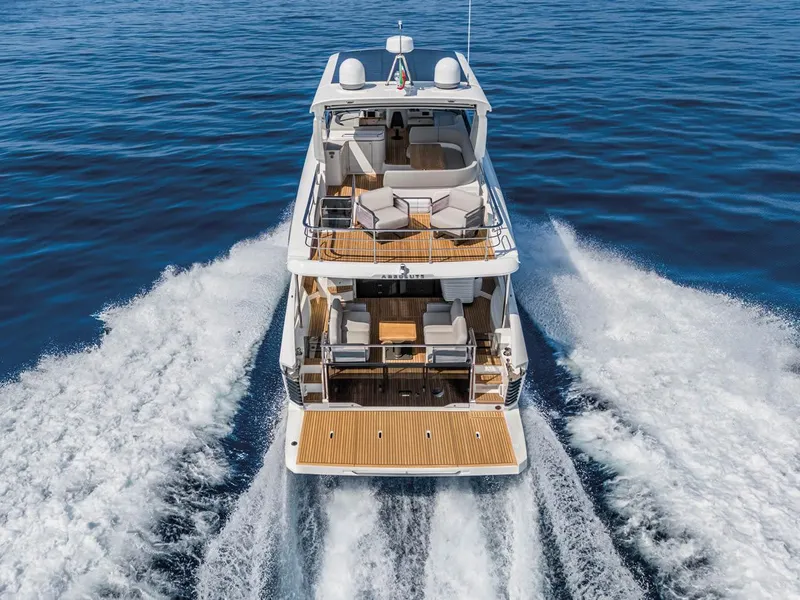 Slide: The Image of 2025 Absolute 53 Navetta yacht cruising on open water, rear view. - 3