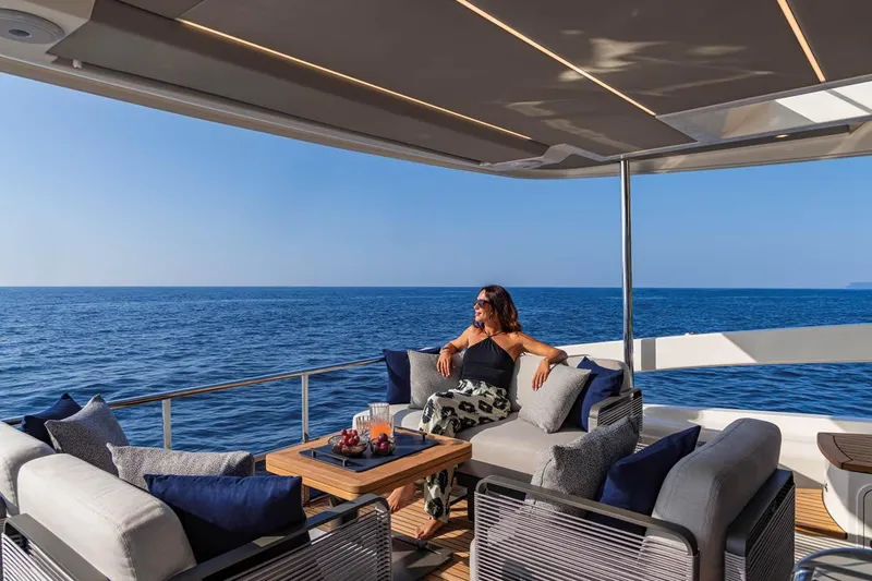 Slide: The Image of Woman relaxing on 2025 Absolute 53 Navetta yacht, enjoying ocean view. - 5