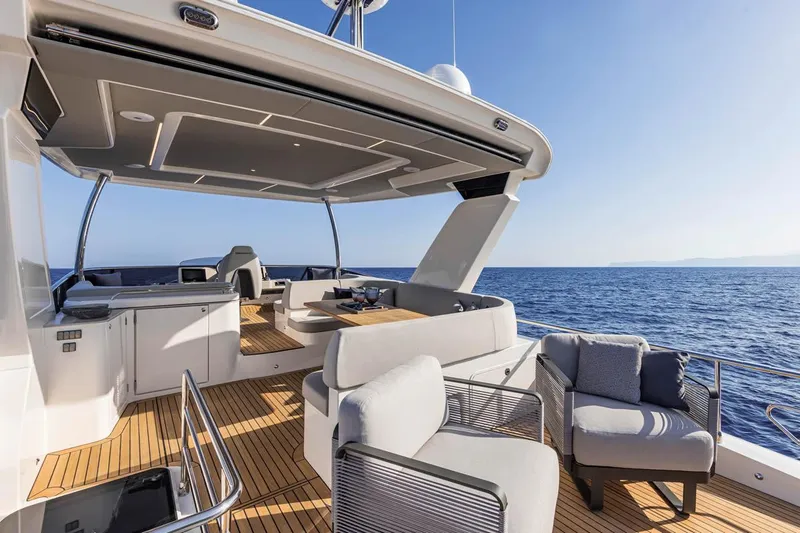 Slide: The Image of Luxurious 2025 Absolute 53 Navetta yacht deck with modern seating and ocean view. - 6