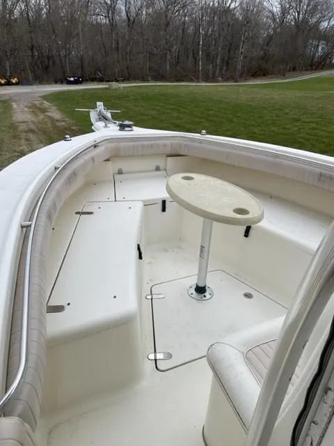 Slide: The Image of 2003 Scout 280 Sportfish boat with seating and table in the bow area. - 13