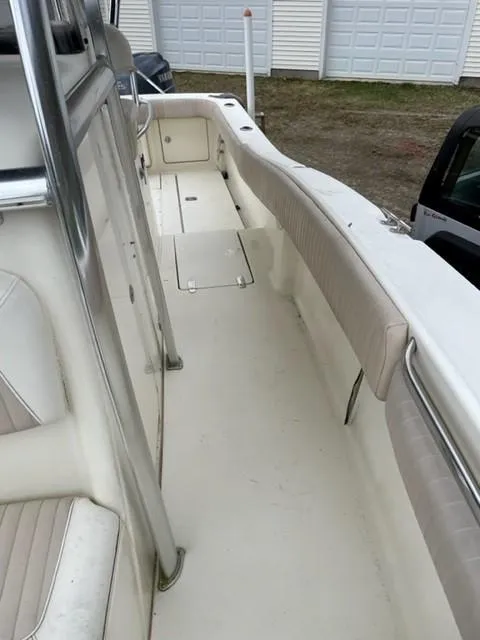 Slide: The Image of 2003 Scout 280 Sportfish boat interior with white seating and storage compartments. - 15