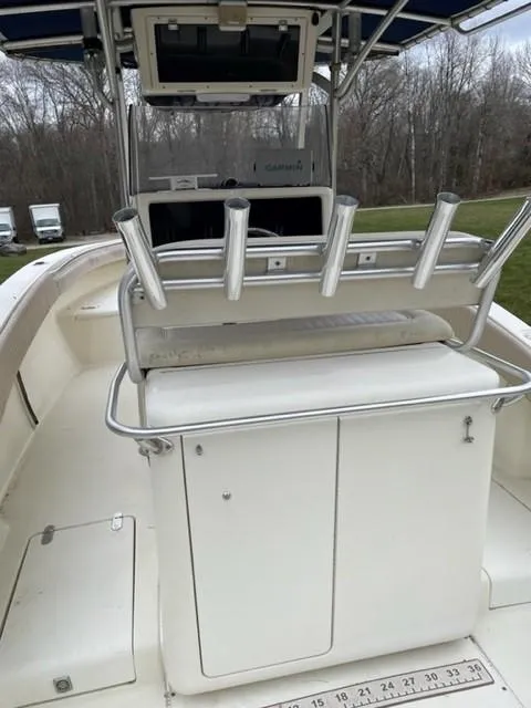 Slide: The Image of 2003 Scout 280 Sportfish boat with rod holders and storage compartments. - 17