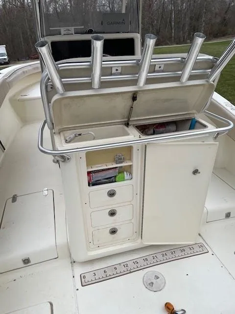 Slide: The Image of 2003 Scout 280 Sportfish boat with open storage compartments and rod holders. - 18