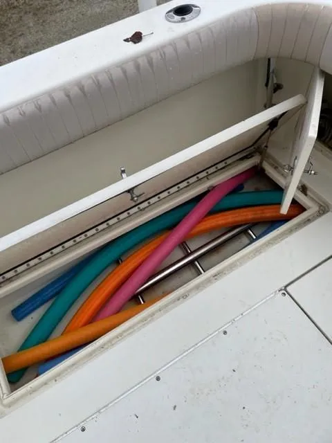 Slide: The Image of Storage compartment on a 2003 Scout 280 Sportfish boat with colorful pool noodles. - 19