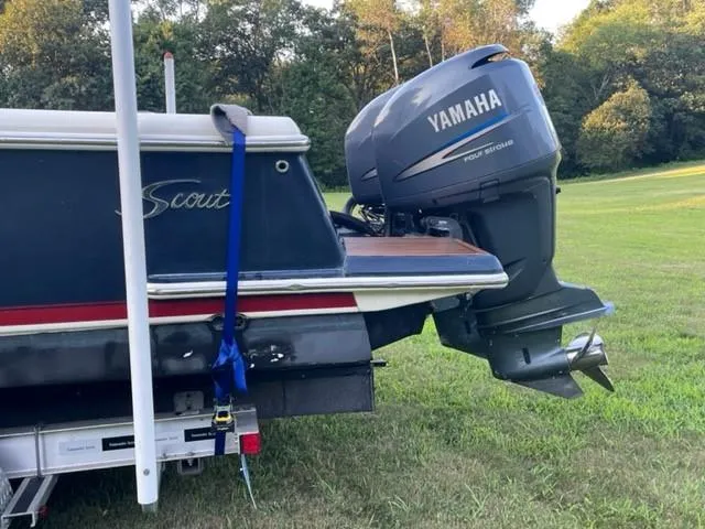 Slide: The Image of 2003 Scout 280 Sportfish boat with Yamaha outboard motor on grassy field. - 5
