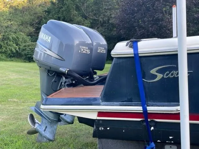Slide: The Image of 2003 Scout 280 Sportfish boat with twin Yamaha 225 engines, parked on grass. - 6