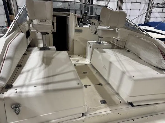 Slide: The Image of 1992 Blackfin 29 Combi boat interior with seating and steering wheel in a marina setting. - 12