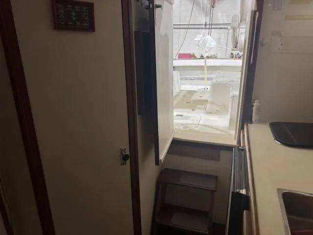 Slide: The Image of Interior view of 1992 Blackfin 29 Combi boat, showing cabin entrance and kitchenette. - 16