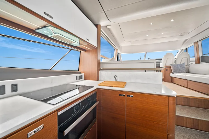 Slide: The Image of 2020 Princess F55 Flybridge yacht interior with modern kitchen and seating area. - 19