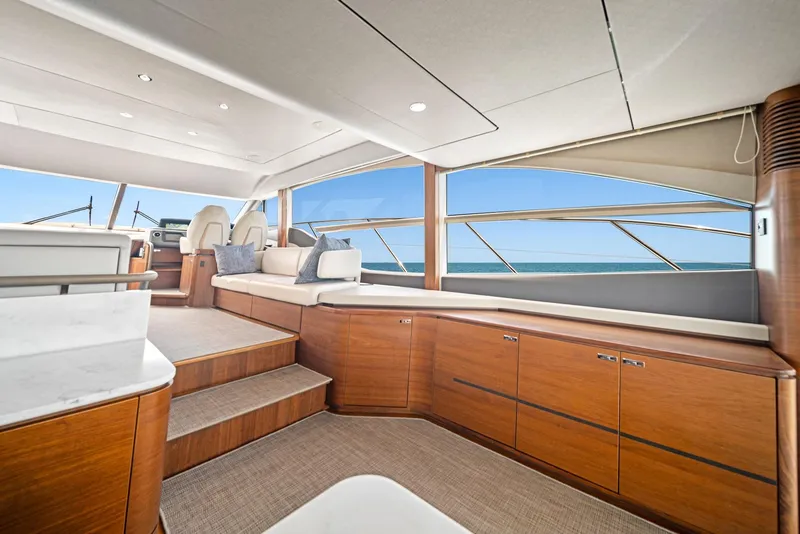 Slide: The Image of Luxurious interior of 2020 Princess F55 Flybridge yacht with panoramic windows and elegant wood finishes. - 20