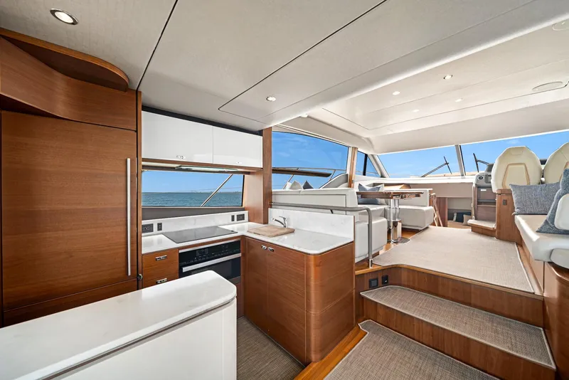 Slide: The Image of Luxurious interior of 2020 Princess F55 Flybridge yacht with modern kitchen and seating area. - 21