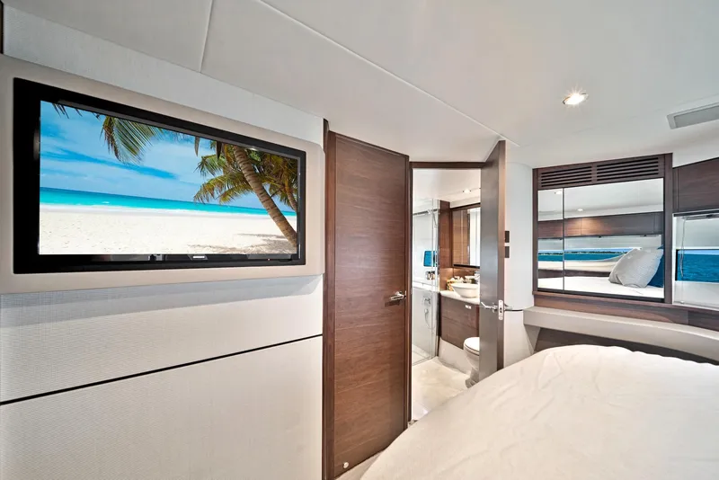 Slide: The Image of Luxurious bedroom interior of 2020 Princess F55 Flybridge yacht with TV and ensuite bathroom. - 27