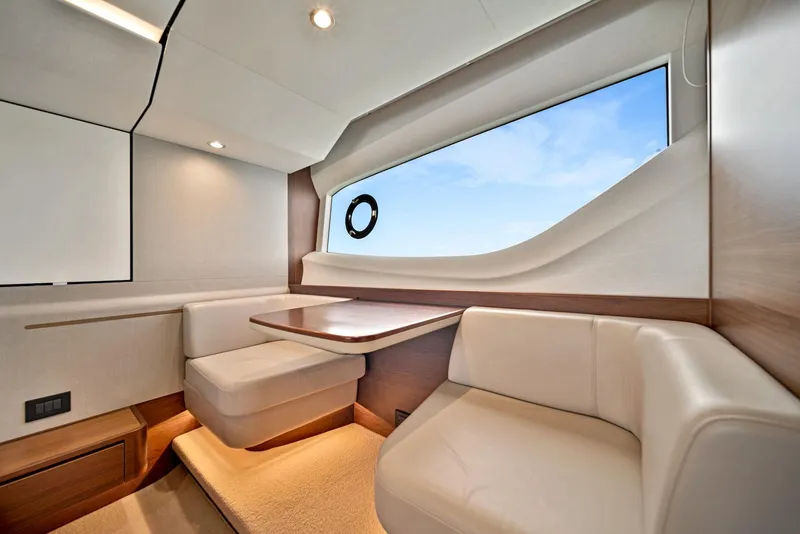 Slide: The Image of Luxurious interior of 2020 Princess F55 Flybridge yacht with modern seating and large window. - 31