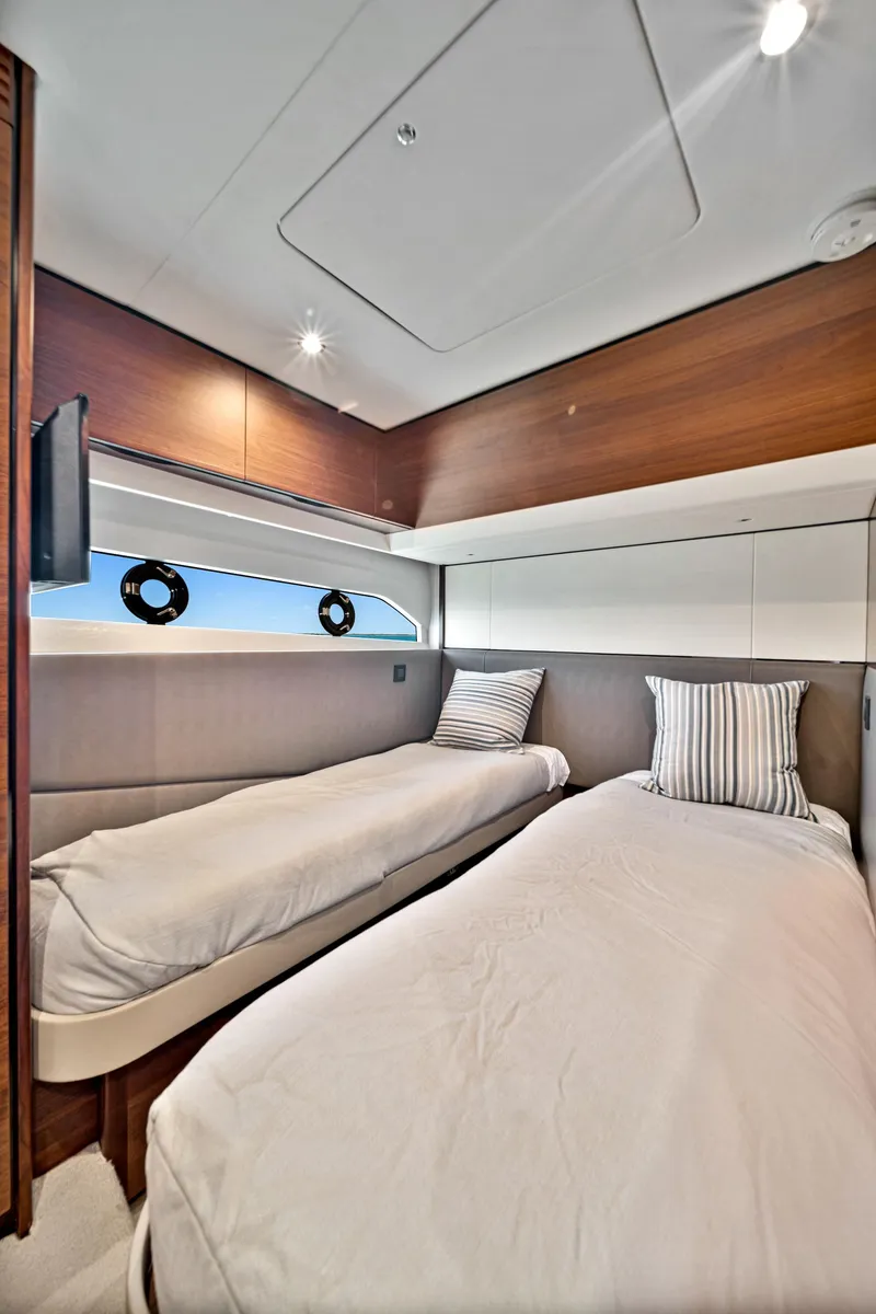 Slide: The Image of 2020 Princess F55 Flybridge twin bed cabin with modern interior design. - 34