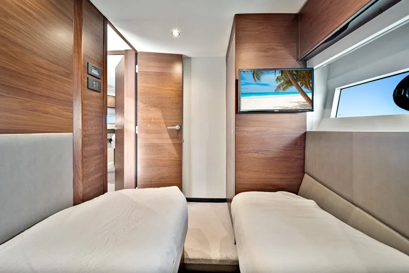 Slide: The Image of Interior cabin of 2020 Princess F55 Flybridge yacht with twin beds and TV. - 36