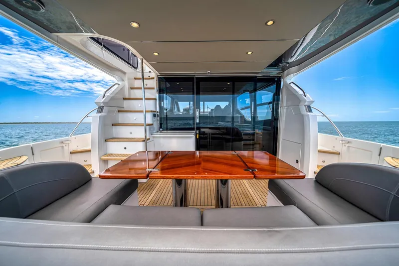 Slide: The Image of Luxury 2020 Princess F55 Flybridge yacht interior with ocean view and elegant seating area. - 44