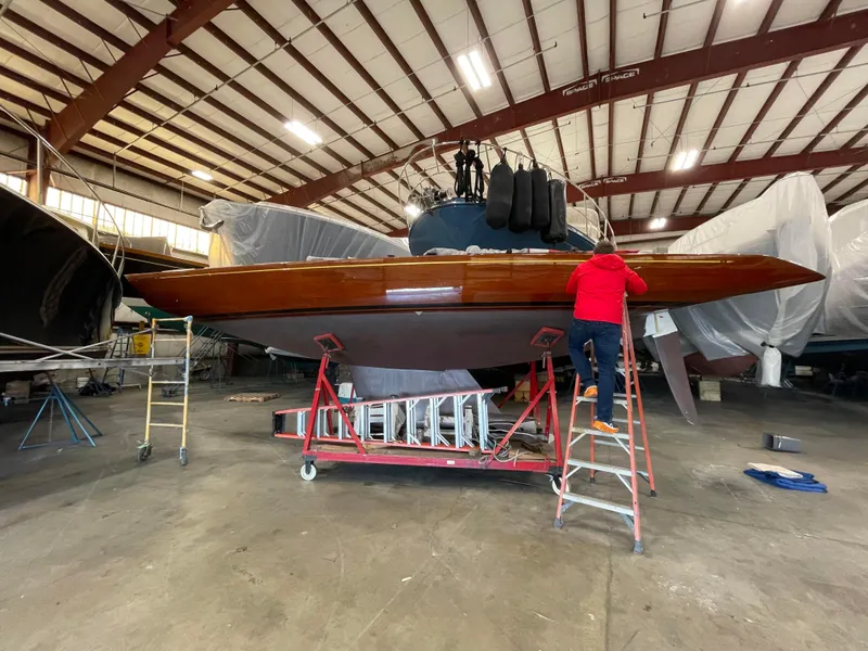 Slide: The Image of 1989 Litton International 6 Metre yacht in a workshop, undergoing maintenance. - 4