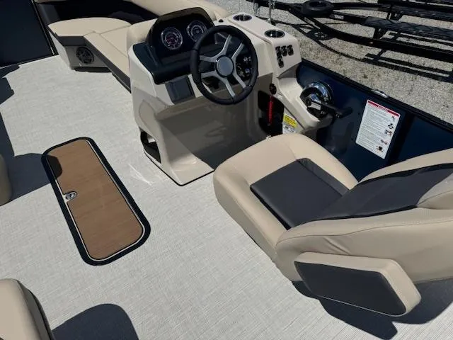 Slide: The Image of 2024 Harris FloteBote 230 Cruiser SLDH boat interior with beige seating and modern dashboard. - 3