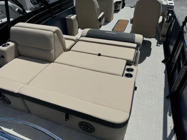 Slide: The Image of 2024 Harris FloteBote 230 Cruiser SLDH interior with beige seating and cup holders. - 7