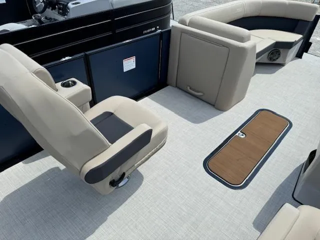 Slide: The Image of 2024 Harris FloteBote 230 Cruiser SLDH interior with beige seating and storage compartment. - 8