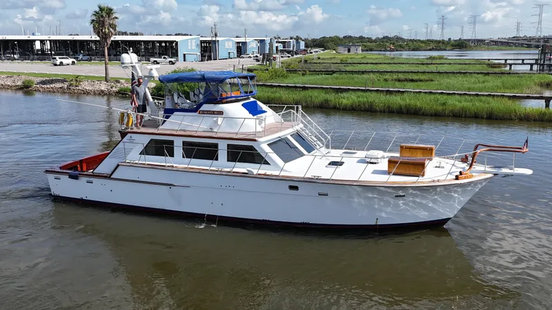 Slide: The Image of 1980 Bertram 58 Convertible Custom yacht cruising on a sunny day. - 2