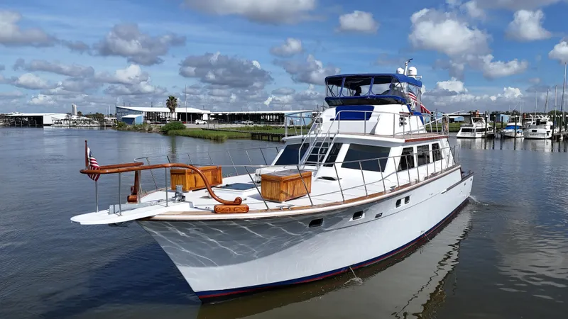 Slide: The Image of 1980 Bertram 58 Convertible Custom yacht on calm water under a blue sky. - 3