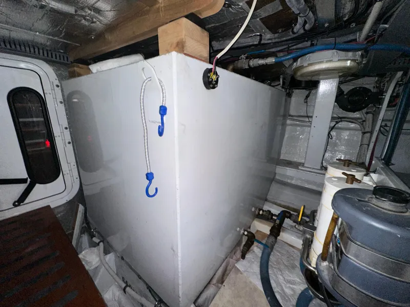 Slide: The Image of Engine room of 1980 Bertram 58 Convertible Custom with storage tank and equipment. - 35