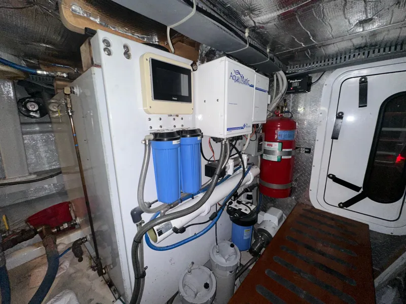 Slide: The Image of Engine room of 1980 Bertram 58 Convertible Custom with water filtration system. - 36