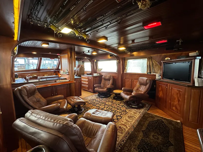 Slide: The Image of Luxurious interior of a 2010 Bertram 58 Convertible yacht with leather seating and wood finishes. - 42
