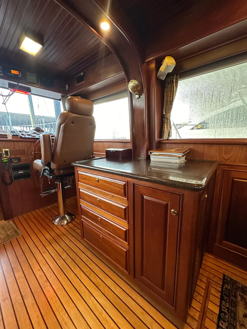 Slide: The Image of Luxurious interior of a 2010 Bertram 58 Convertible yacht with wooden cabinetry and captain's chair. - 46