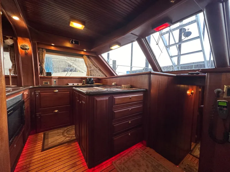 Slide: The Image of Luxurious wooden interior of a 2010 Bertram 58 Convertible yacht kitchen. - 49