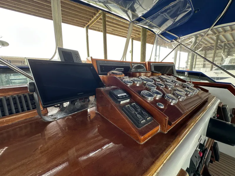 Slide: The Image of Control panel of 1980 Bertram 58 Convertible Custom yacht with wooden dashboard and gauges. - 18