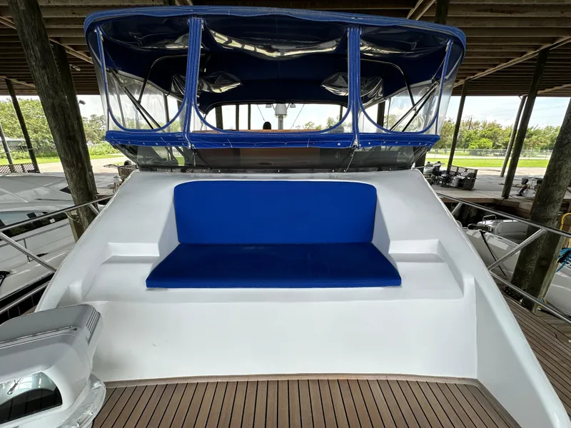 Slide: The Image of 1980 Bertram 58 Convertible Custom yacht with blue seating and covered helm. - 20