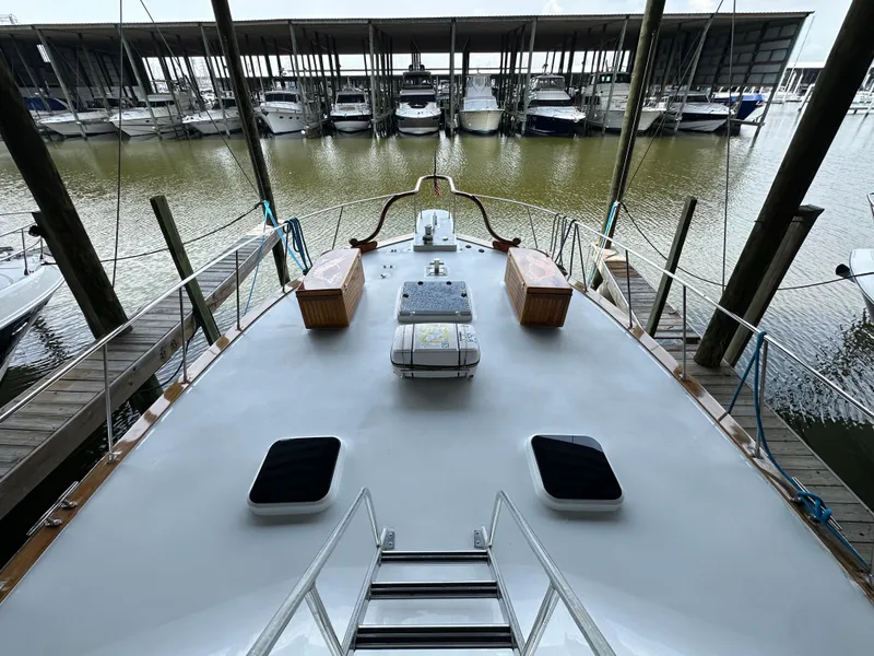 Slide: The Image of 1980 Bertram 58 Convertible Custom yacht docked at marina, view from deck. - 21