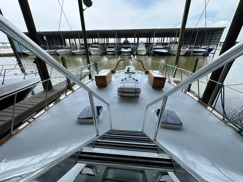 Slide: The Image of 1980 Bertram 58 Convertible Custom yacht docked in marina, view from deck. - 22