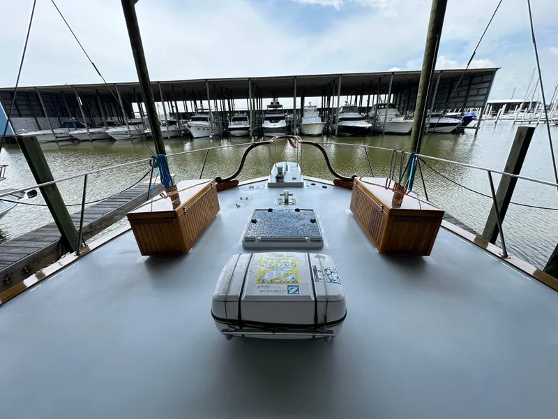 Slide: The Image of 1980 Bertram 58 Convertible Custom yacht deck view at marina. - 23