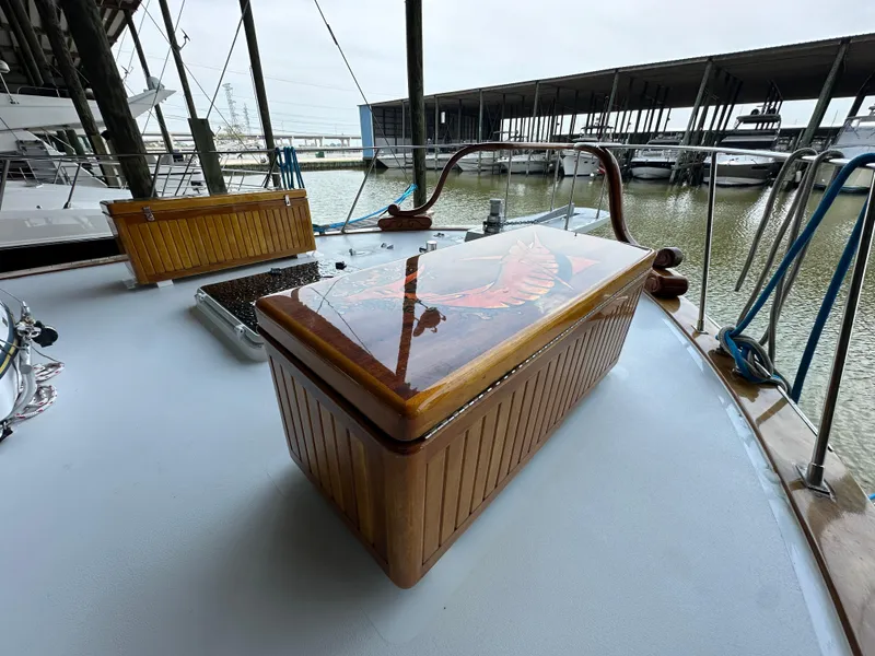 Slide: The Image of 1980 Bertram 58 Convertible Custom yacht deck with wooden storage box. - 24