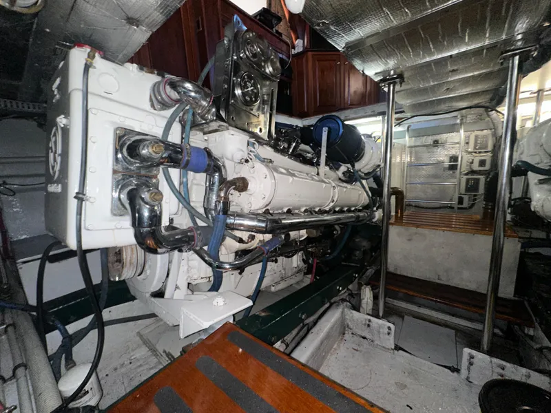 Slide: The Image of Engine room of 1980 Bertram 58 Convertible Custom yacht, showcasing detailed machinery and components. - 27