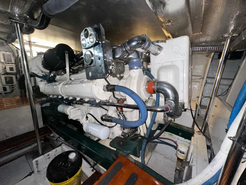 Slide: The Image of Engine room of 1980 Bertram 58 Convertible Custom yacht, showcasing detailed machinery and components. - 28