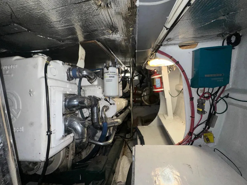 Slide: The Image of Engine room of 1980 Bertram 58 Convertible Custom yacht, showcasing mechanical components and wiring. - 29