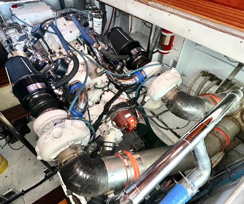 Slide: The Image of Engine room of 1980 Bertram 58 Convertible Custom yacht, showcasing complex machinery and components. - 31