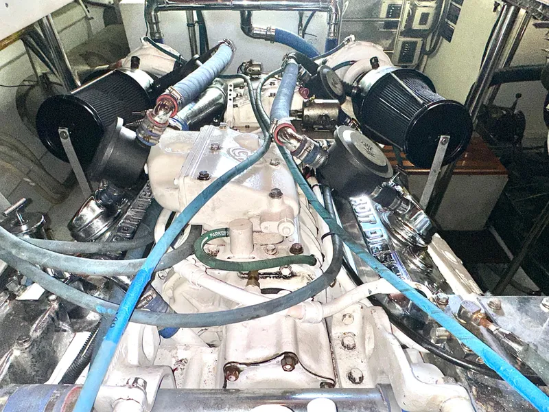Slide: The Image of Engine room of 1980 Bertram 58 Convertible Custom with visible hoses and components. - 32