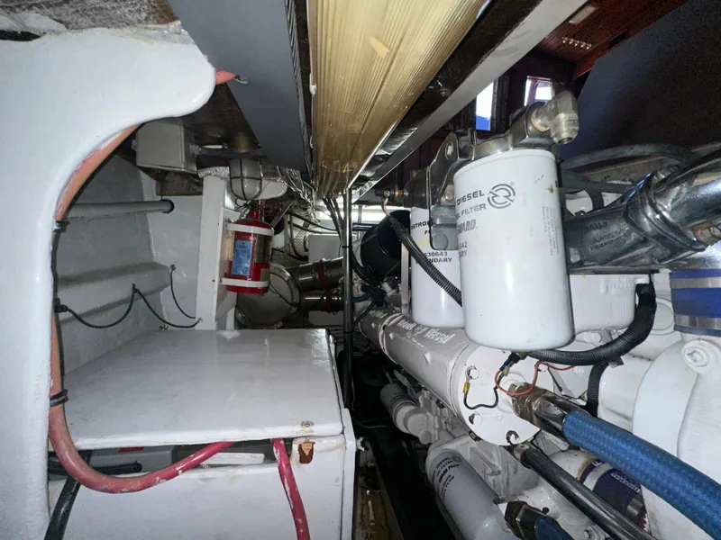 Slide: The Image of Engine room of 1980 Bertram 58 Convertible Custom with visible filters and wiring. - 34