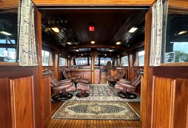 Slide: The Image of Luxurious interior of 1980 Bertram 58 Convertible Custom yacht with wood paneling and leather seating. - 37