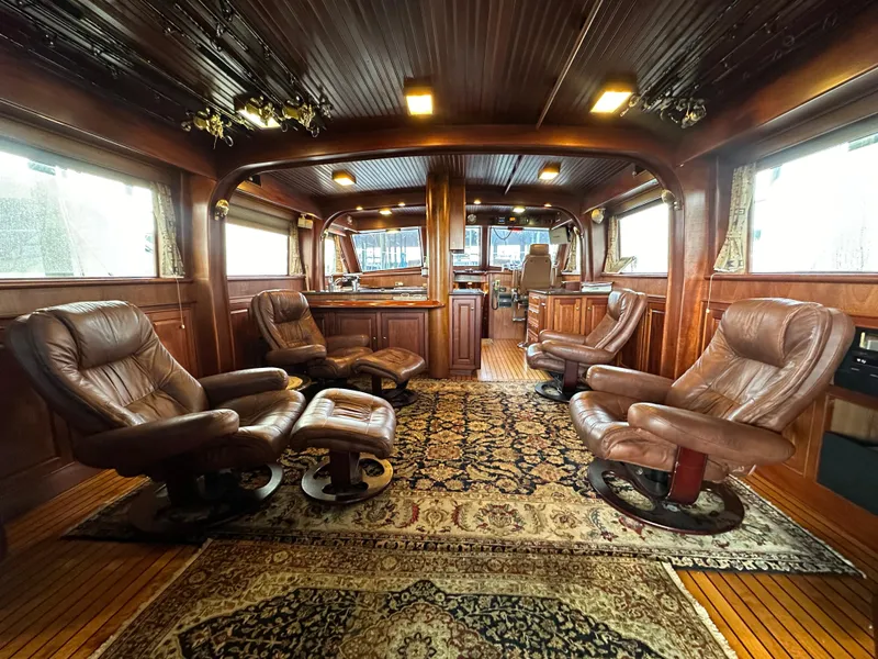 Slide: The Image of Luxurious interior of 1980 Bertram 58 Convertible Custom yacht with leather seating and wood paneling. - 38